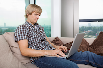 Man checking for social media updates on his laptop