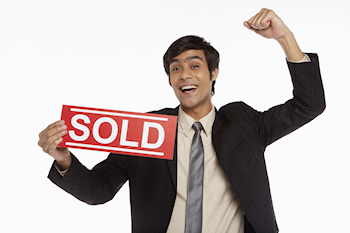 Man holding sold sign