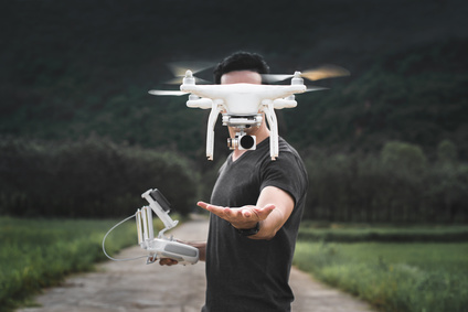 man with drone flying ahead of him